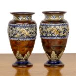 Royal Doulton Lambeth Pair of oviform vases, decorated with bands of lizards, beetles and leaves,