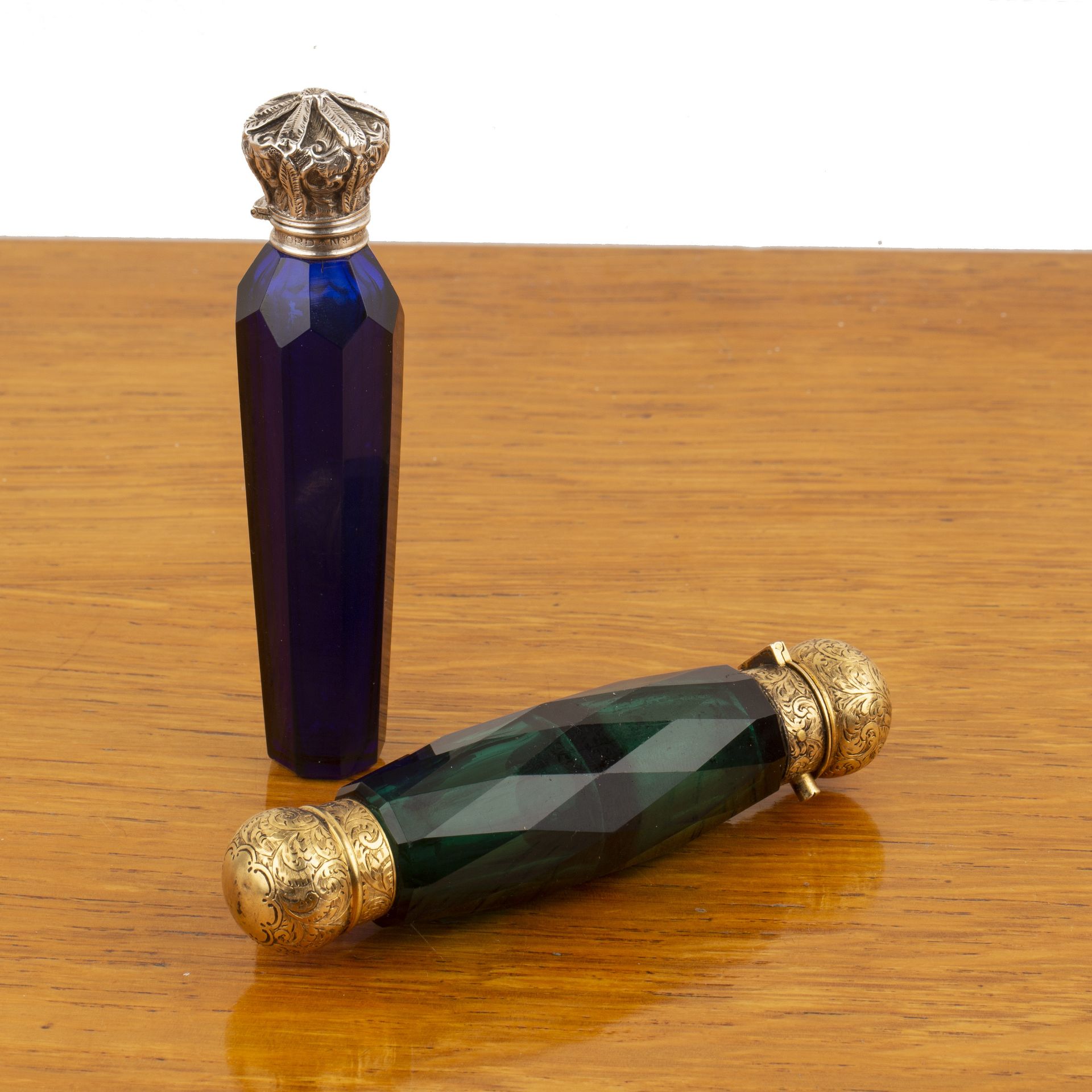 Two Sampson Mordan scent bottles the first with cobalt blue glass body, with white metal mounts