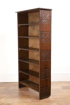Arts and Crafts oak and stained pine, narrow bookcase, with carved decoration of stylised flowers to