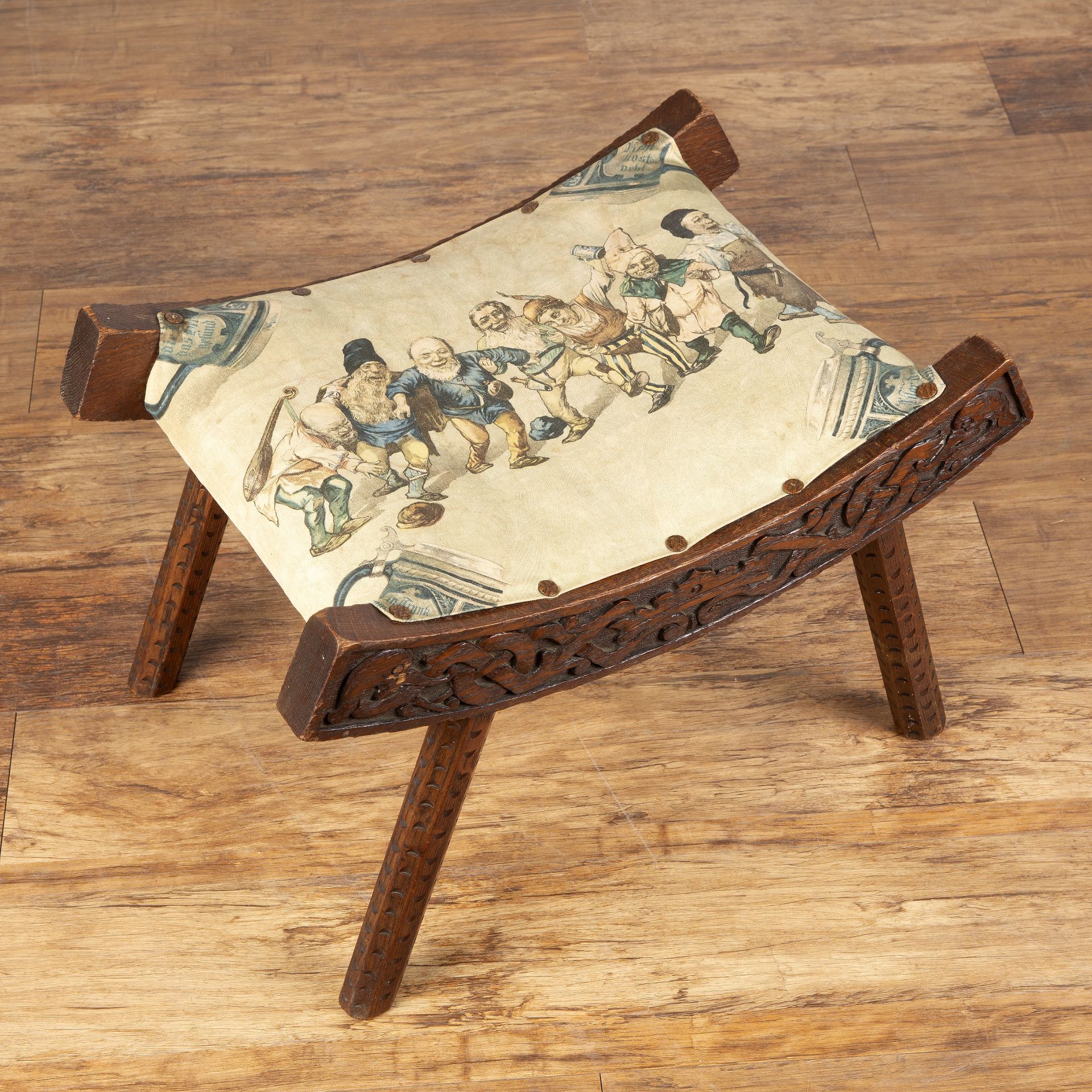 Celtic style carved wooden stool In the manner of Alexander Ritchie from Iona, oak, with upholstered