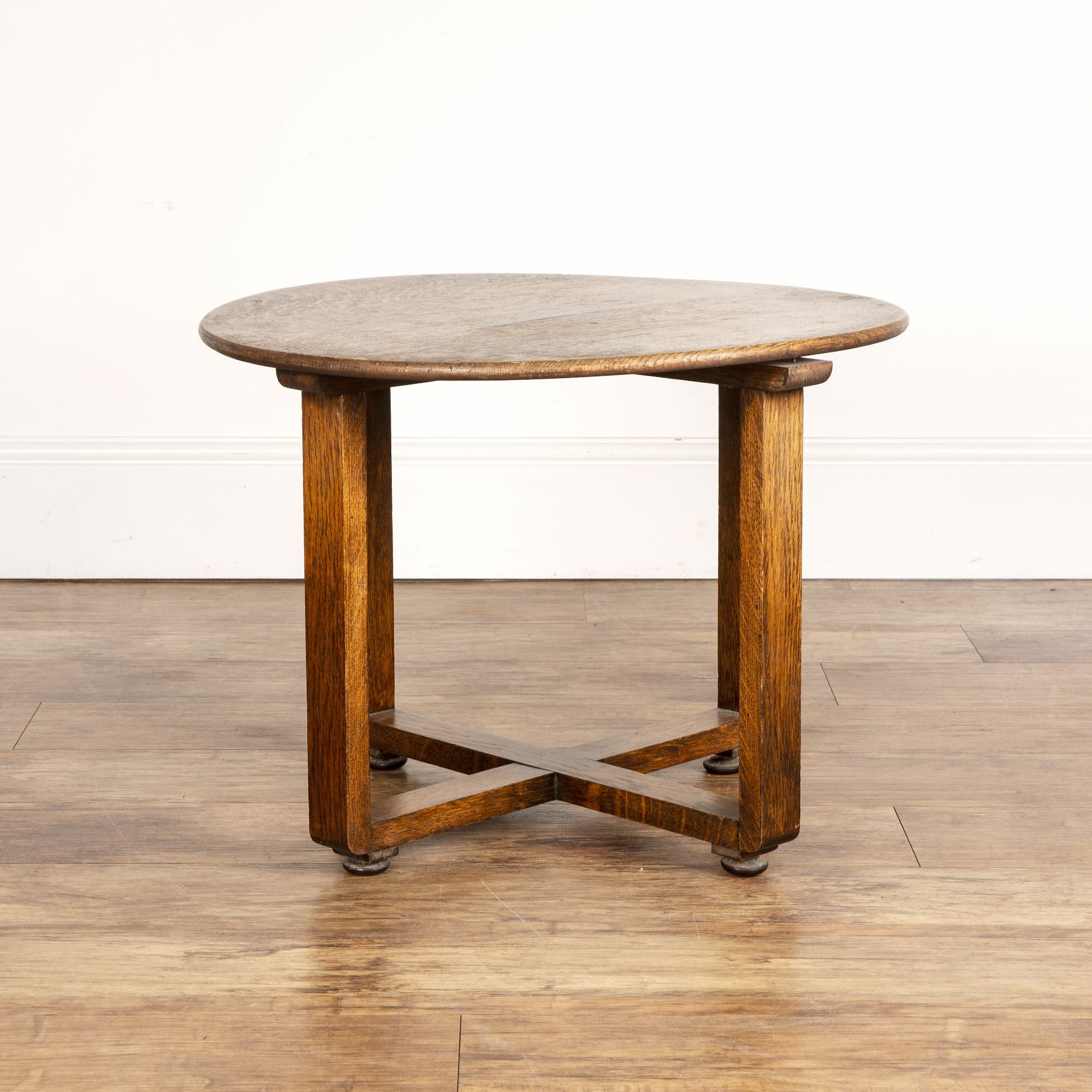 In the manner of Heals oak, circular topped table, unmarked, 60.5cm wide x 45cm high Overall signs