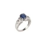 A sapphire and diamond dress ring, the oval mixed-cut sapphire claw set between graduating shoulders