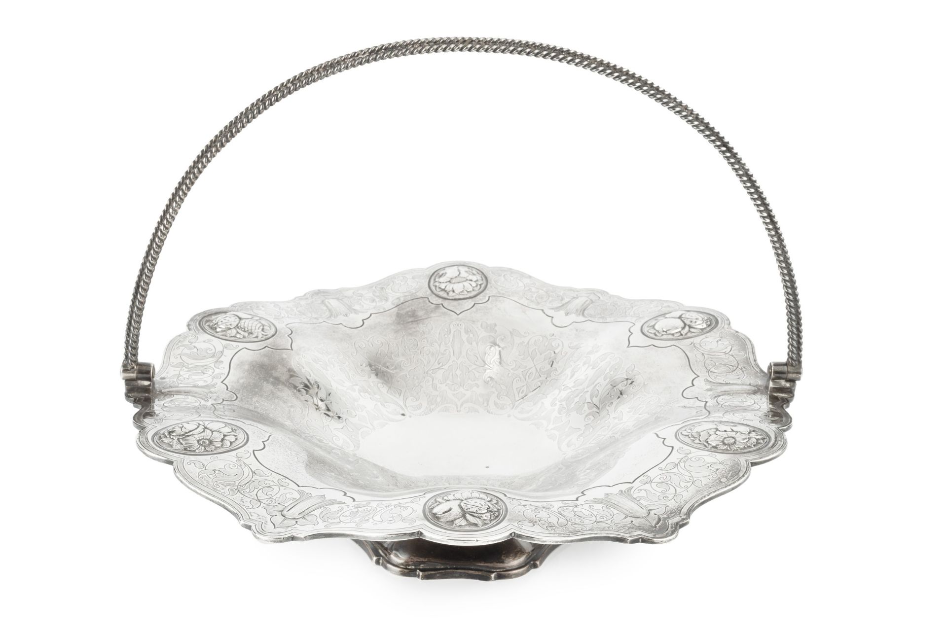 A mid Victorian silver swing handled fruit stand, of shaped undulating form, the borders embossed