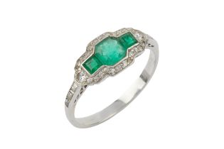 An emerald and diamond Art Deco style ring, the central octagonal cut emerald flanked by two smaller