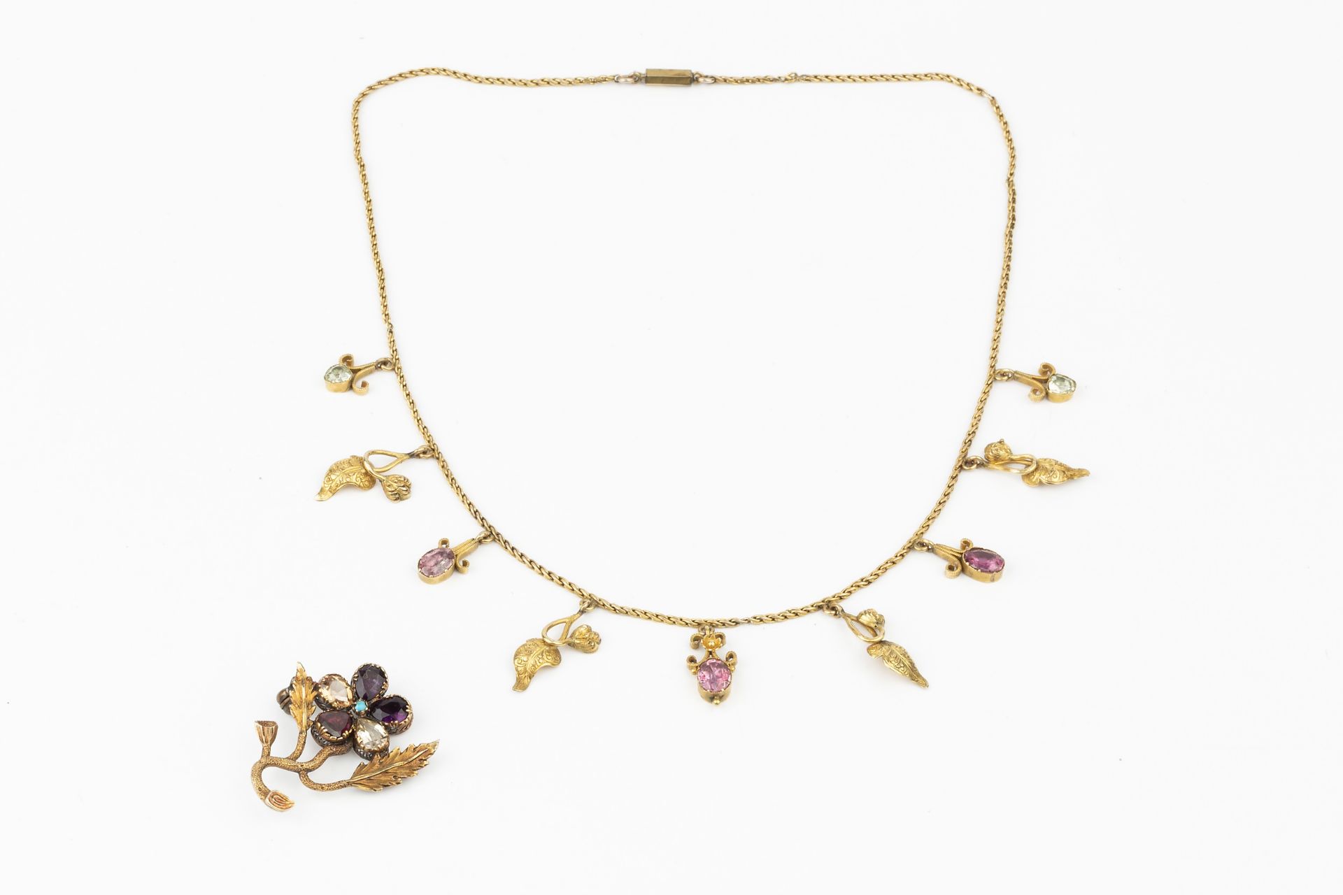 A small collection of jewellery, comprising a gem set flower brooch, a yellow metal necklace hung - Image 2 of 4