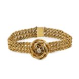 An Austro Hungarian gold bracelet, of flexible multi-link design, centred with a textured knot