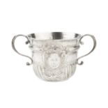 A Queen Anne Britannia standard silver porringer, with ropetwist girdled upper body and part lobed