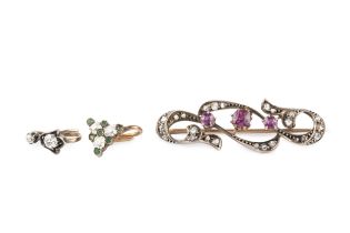 An Edwardian ruby and diamond bar brooch, of scrolling foliate form, centred with three small