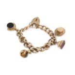A 9ct gold curb link charm bracelet, with engraved padlock clasp, hung with various charms including