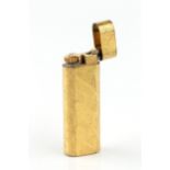 A gold plated lighter by Cartier, of rounded rectangular form and having textured decoration, no.