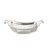 A late Victorian silver cake basket, of rounded rectangular form with scroll ends, having