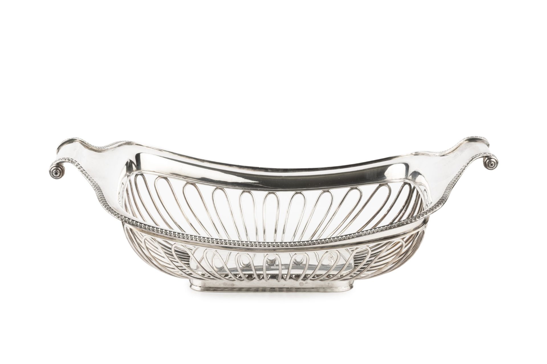 A late Victorian silver cake basket, of rounded rectangular form with scroll ends, having