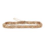 A 9ct gold gatelink bracelet, the links of shaped and wavy rectangular design, 19cm long approx