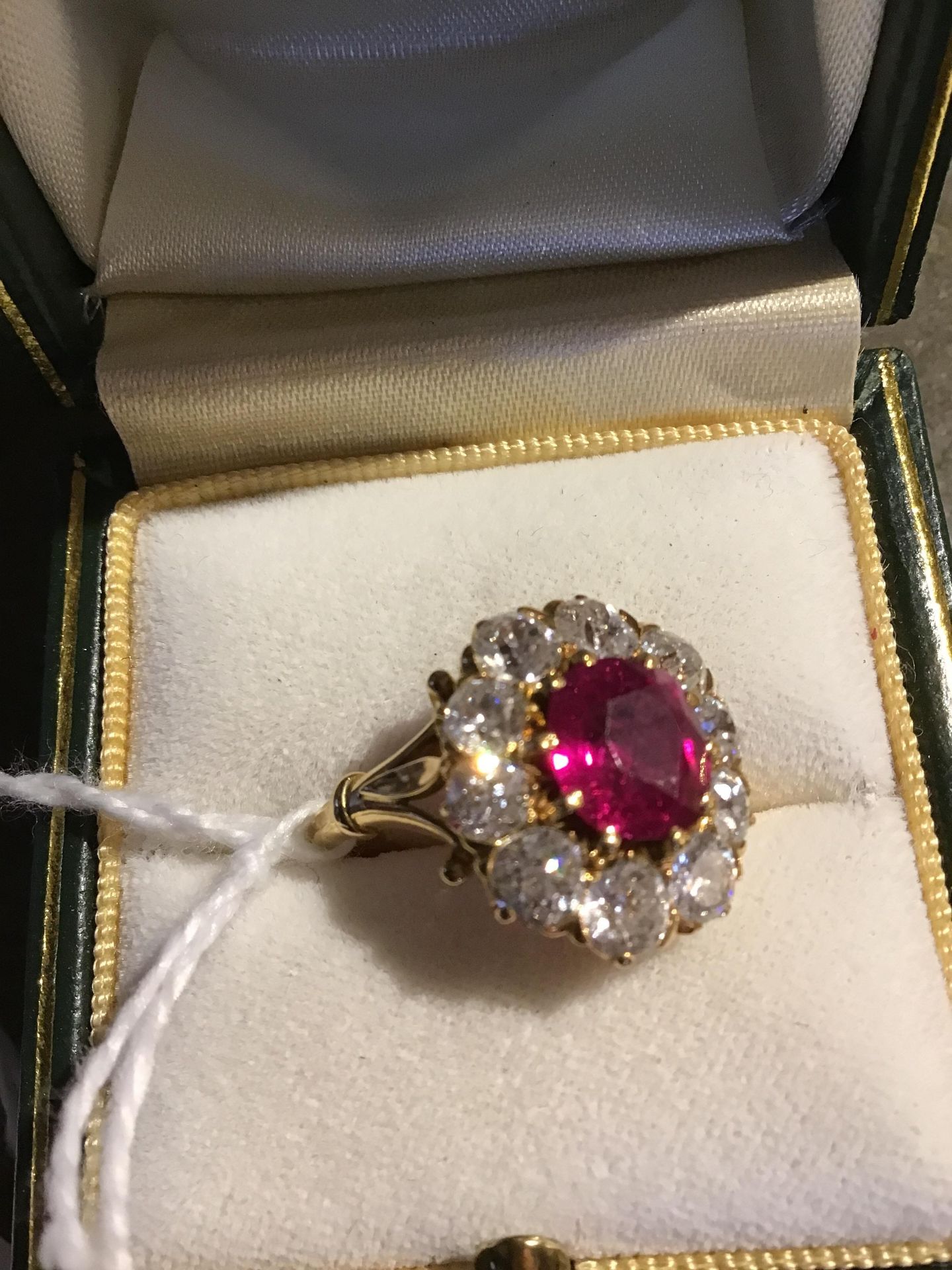 A ruby and diamond cluster ring, the central oval cut ruby within a border of ten old brilliant - Bild 7 aus 14