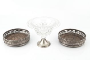 A pair of silver bottle coasters, with pierced decoration and turned hardwood bases, by Richards &