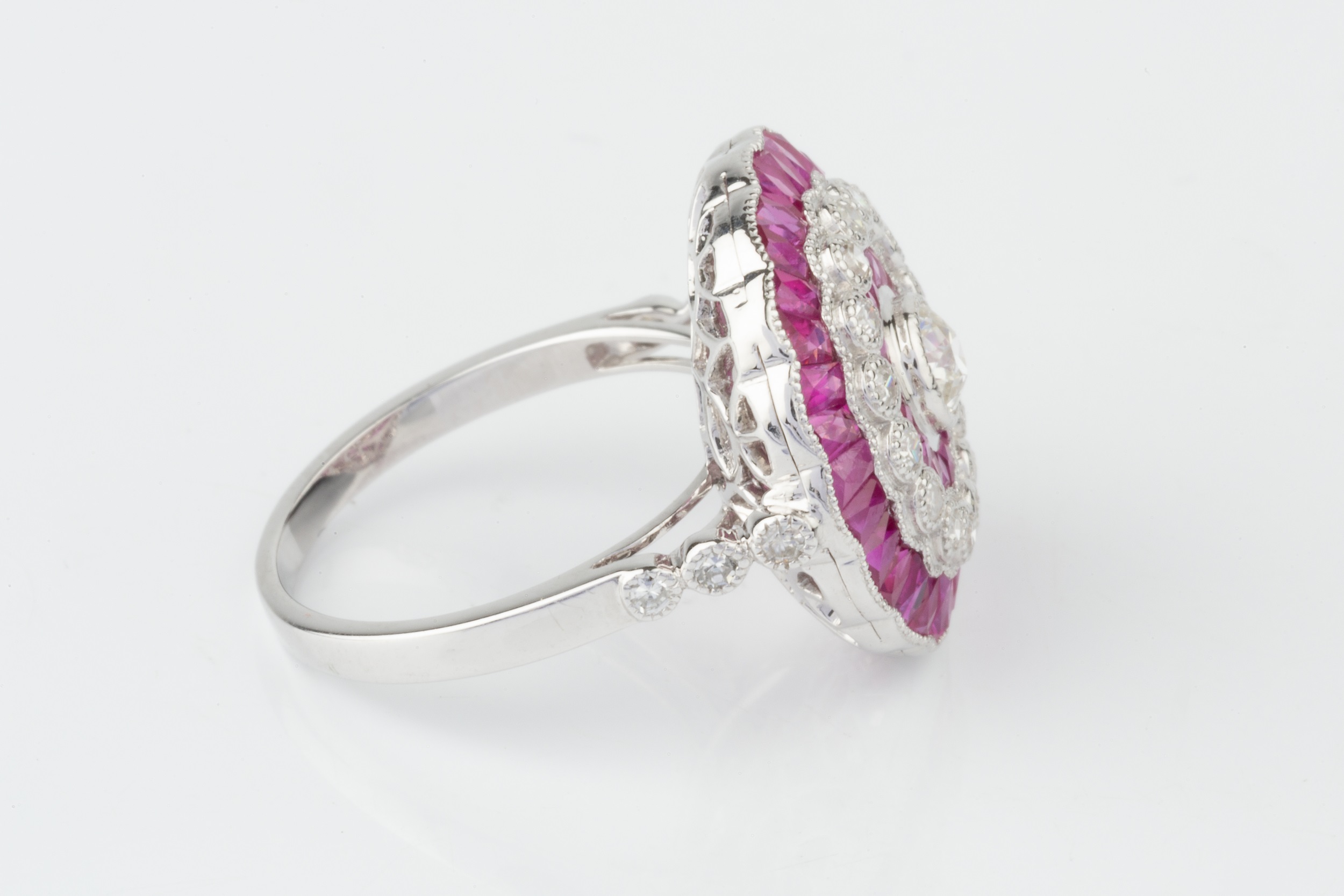 A ruby and diamond cocktail ring, of target design, centred with an old cut diamond within a - Image 2 of 4