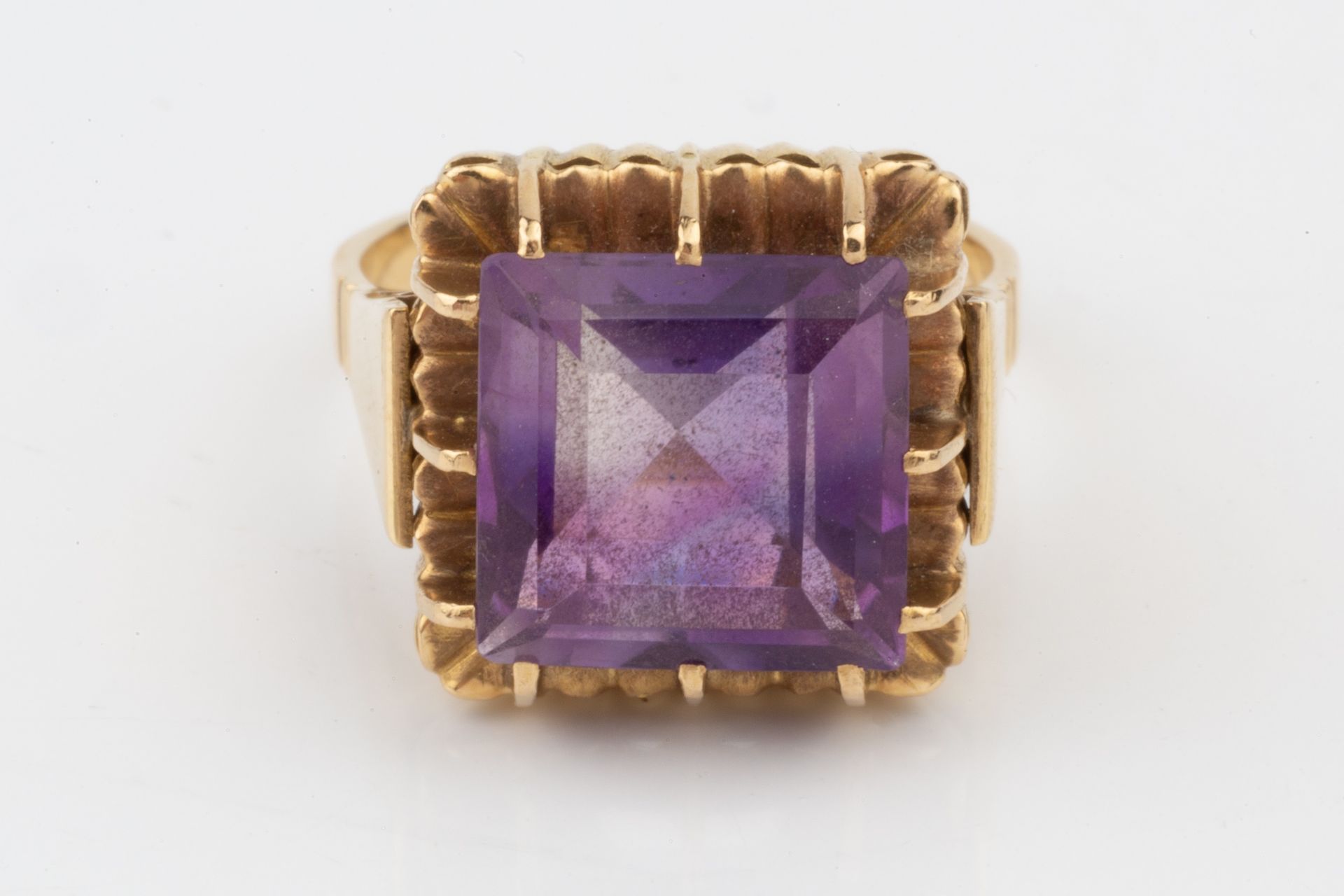 An amethyst cocktail ring, the square cut stone with raised claw setting to a yellow precious - Image 2 of 4