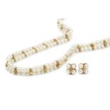 An 18ct gold and cultured pearl twin strand choker, the two strands united by alternating diamond