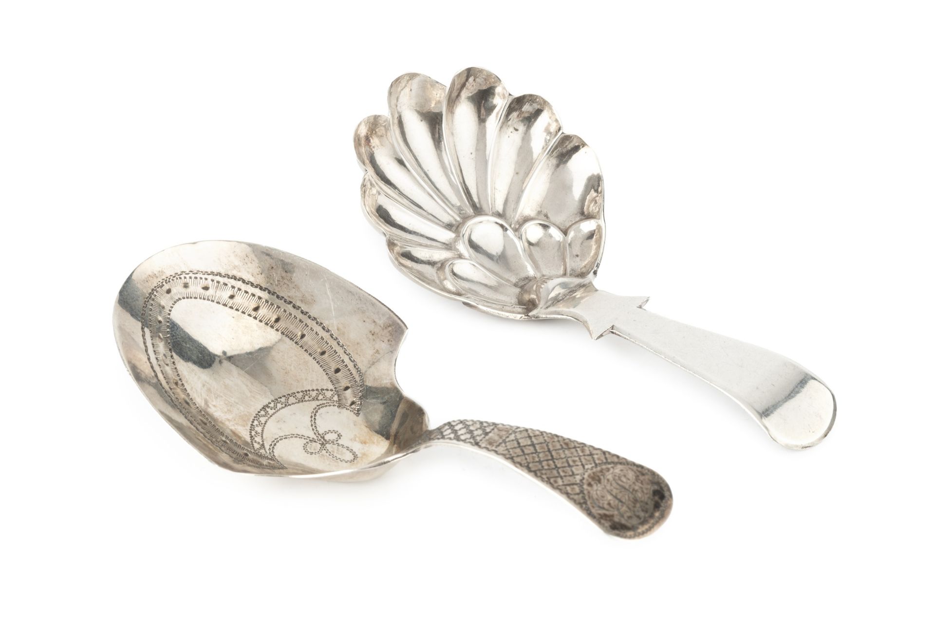 A George III silver caddy spoon, with bright-cut shield shaped bowl and chequered handle, maker I.
