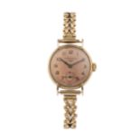 A lady's 9ct gold wristwatch by Longines, the circular dial with seconds subsidiary dial, the