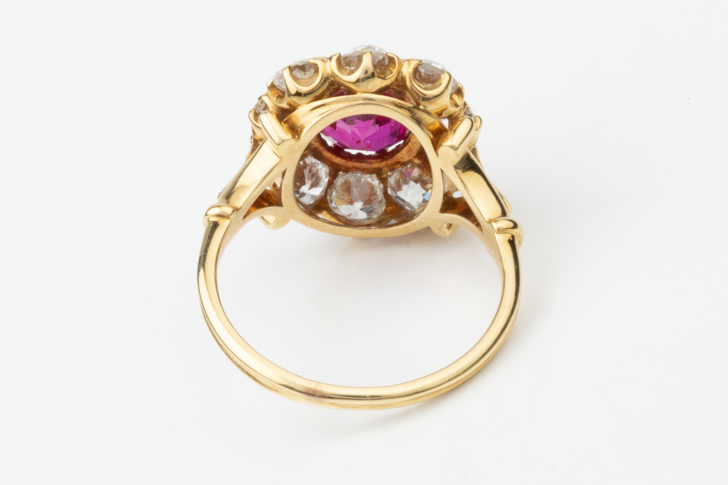 A ruby and diamond cluster ring, the central oval cut ruby within a border of ten old brilliant - Image 2 of 14