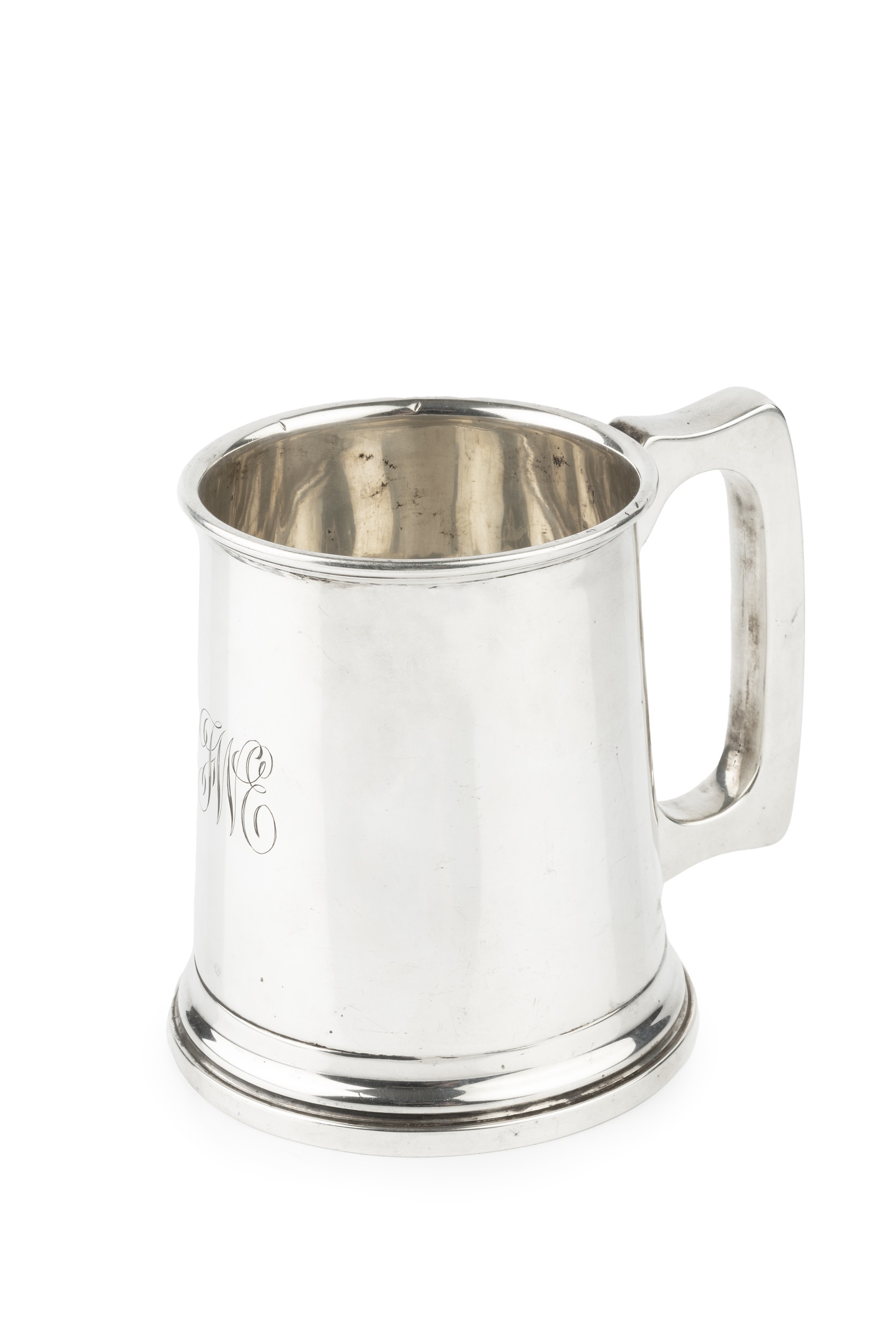 A George V silver pint tankard, of plain design with shaped handle, engraved initials, by William