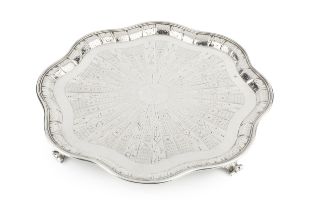 A late Victorian silver salver, of wavy outline, having reeded border and engraved with stylised