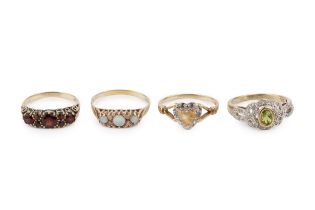 A 9ct gold, citrine and diamond dress ring, having oval collet set central stone within diamond
