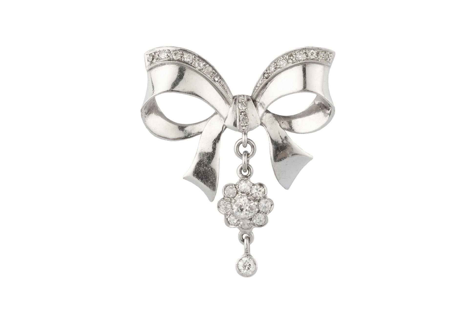A diamond bow brooch, the stylised ribbon bow edged with graduated old, single and lasque-cut