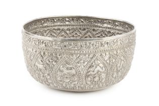 A Burmese white metal thabeik bowl, embossed and engraved with numerous animals and stylised foliage