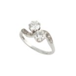 A diamond two stone ring, the brilliant-cut stones each of approx 0.5ct in a crossover setting, claw