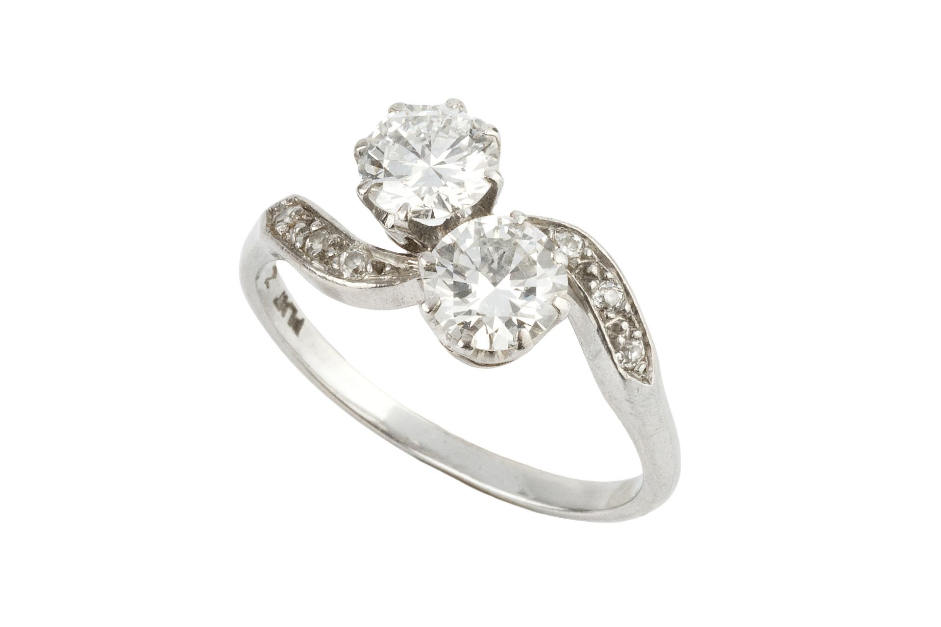 A diamond two stone ring, the brilliant-cut stones each of approx 0.5ct in a crossover setting, claw