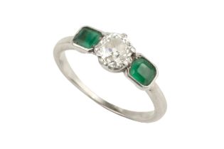 A diamond and emerald three stone ring, the central old-cut diamond in claw setting, between two