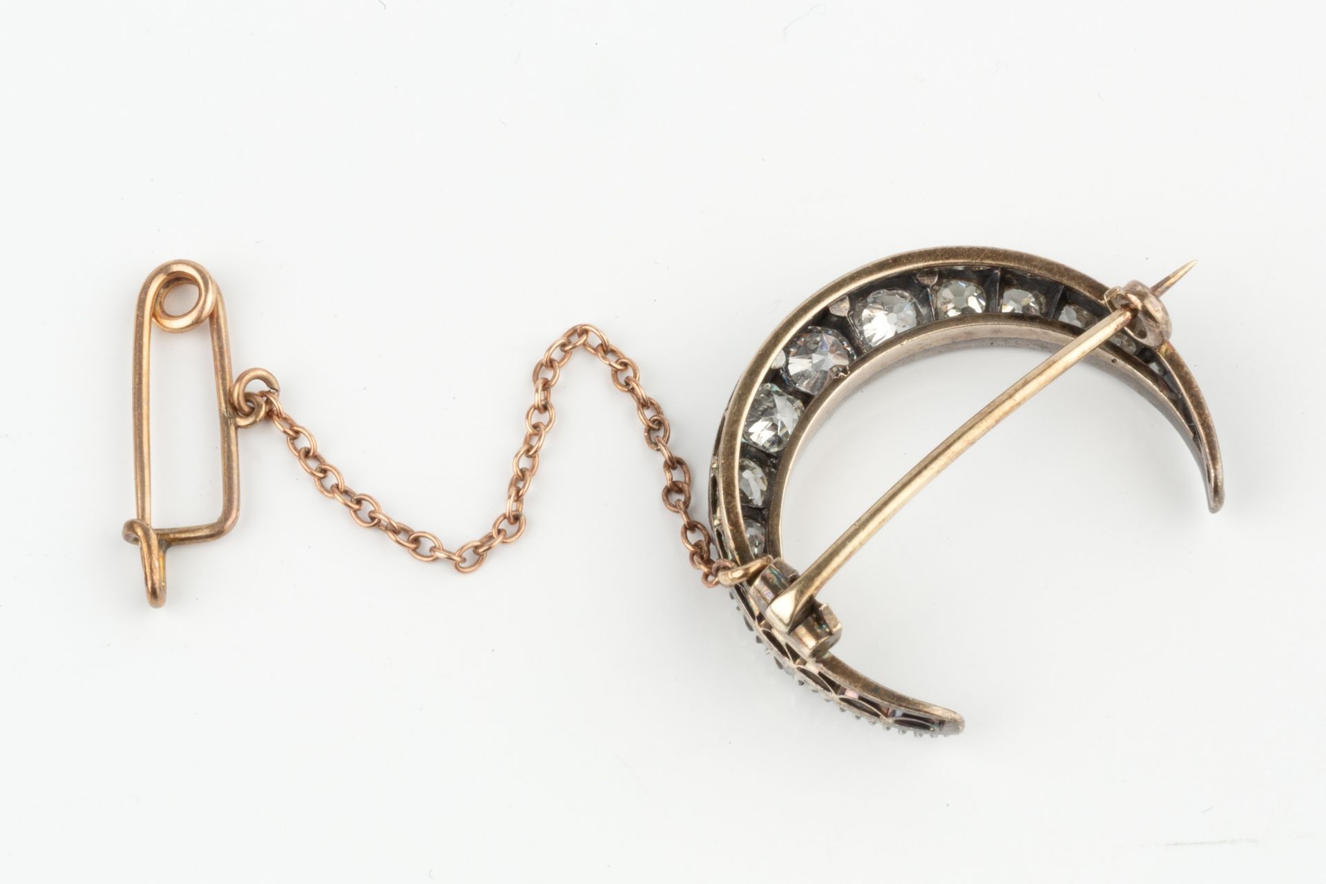 A diamond crescent brooch, set with thirteen graduated brilliant cut stones, the largest approx 0. - Image 2 of 3
