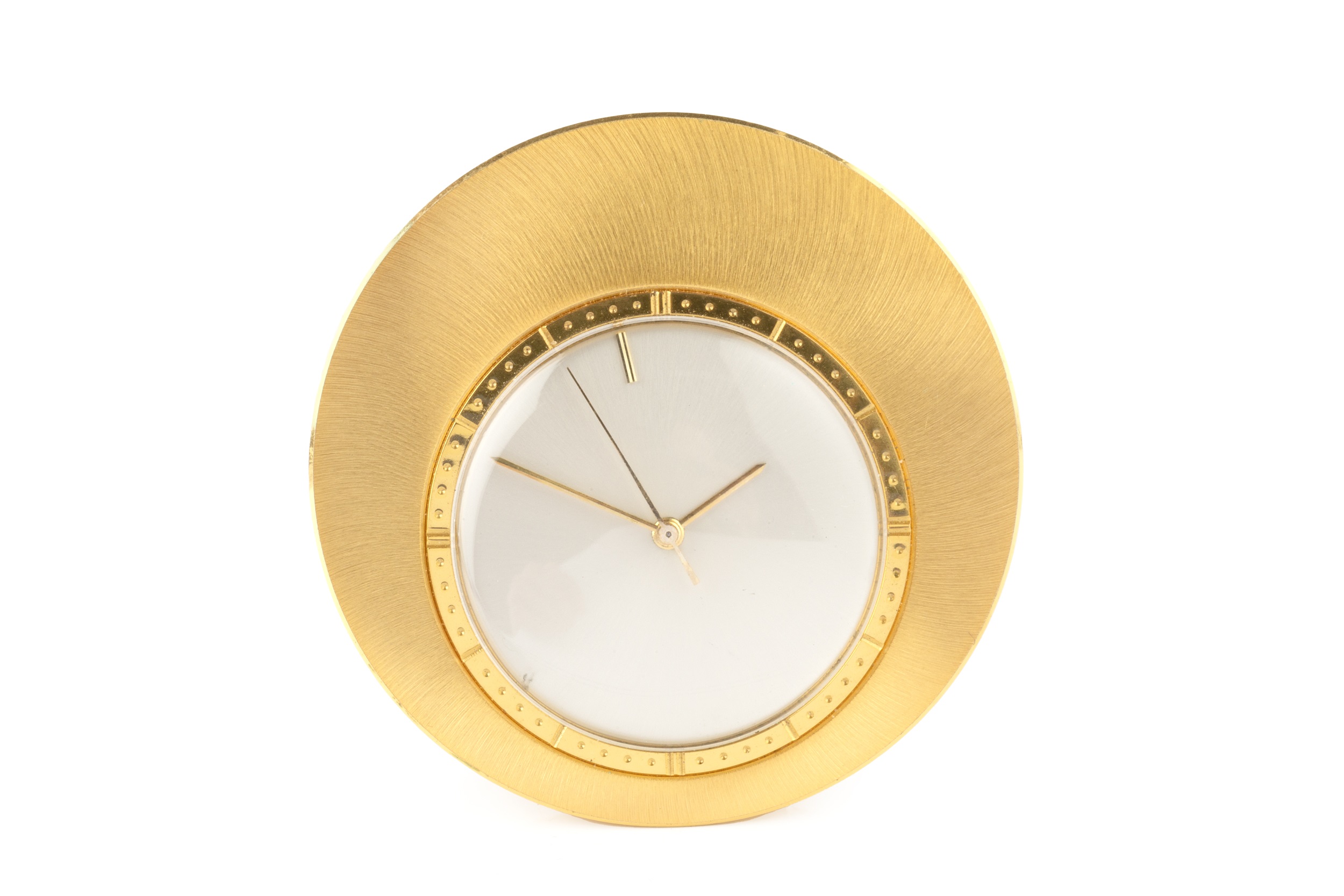 A Jaeger-LeCoultre gold plated circular travel timepiece, with circular silvered dial, and