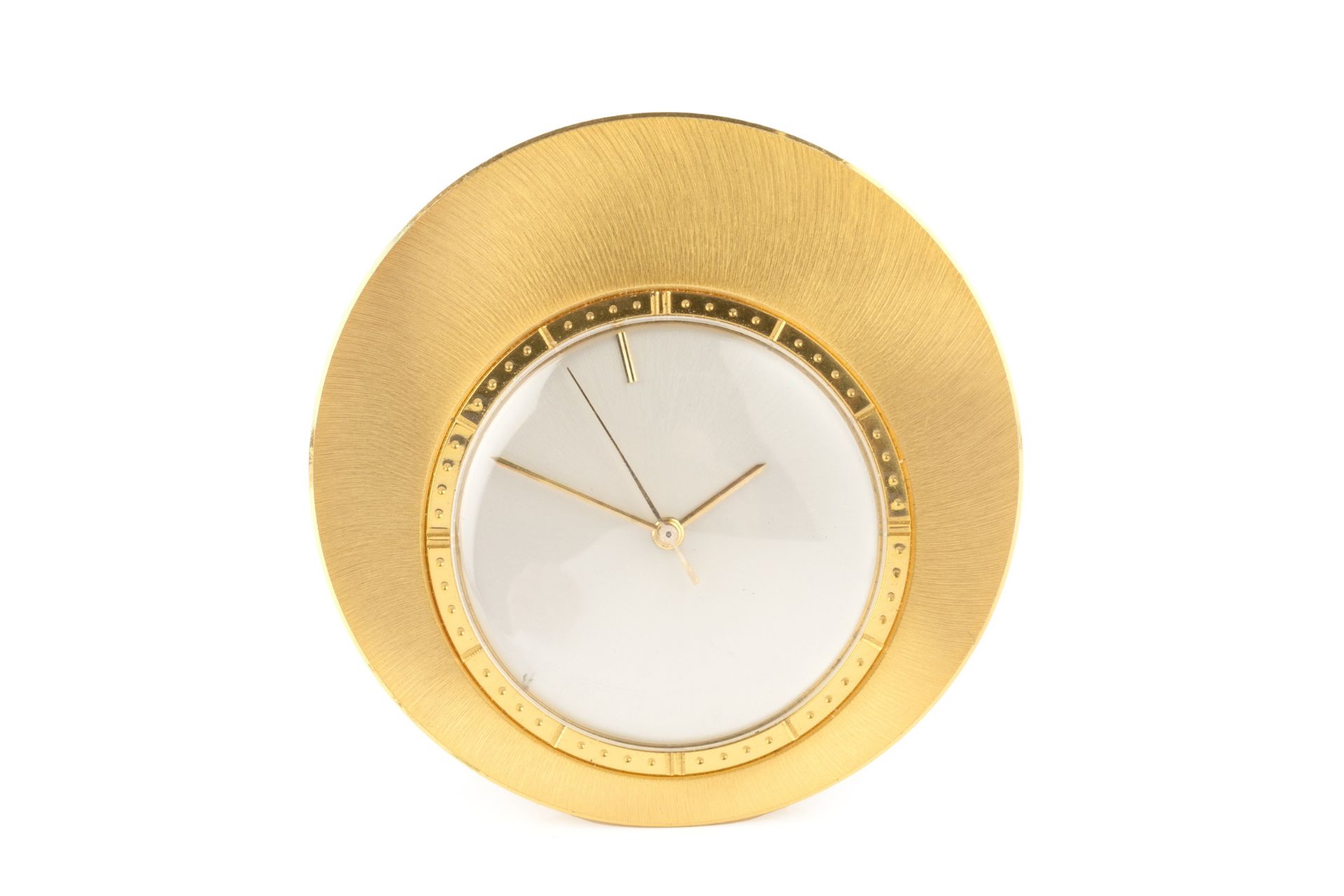 A Jaeger-LeCoultre gold plated circular travel timepiece, with circular silvered dial, and