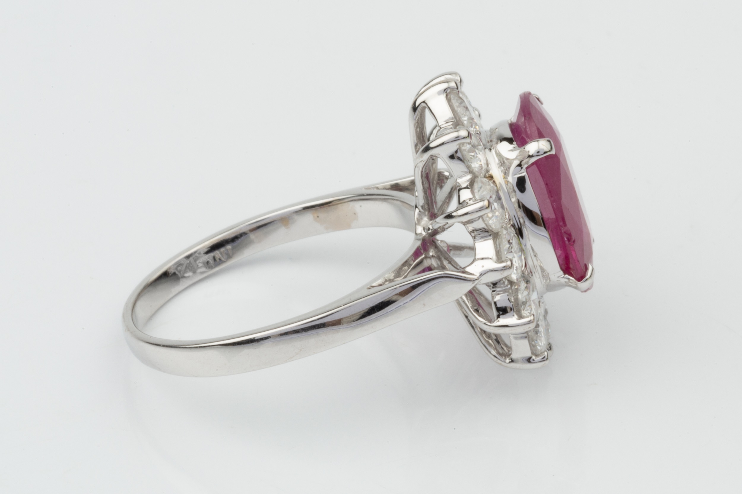 A ruby and diamond cluster ring, the oval mixed cut ruby within a border of twelve round brilliant - Image 4 of 4