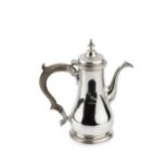 A George II silver coffee pot, of baluster form, the hinged domed cover with urn finial and having