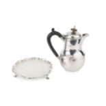 A George V silver hot milk pot, of baluster form with hinged cover and ebonised handle, by