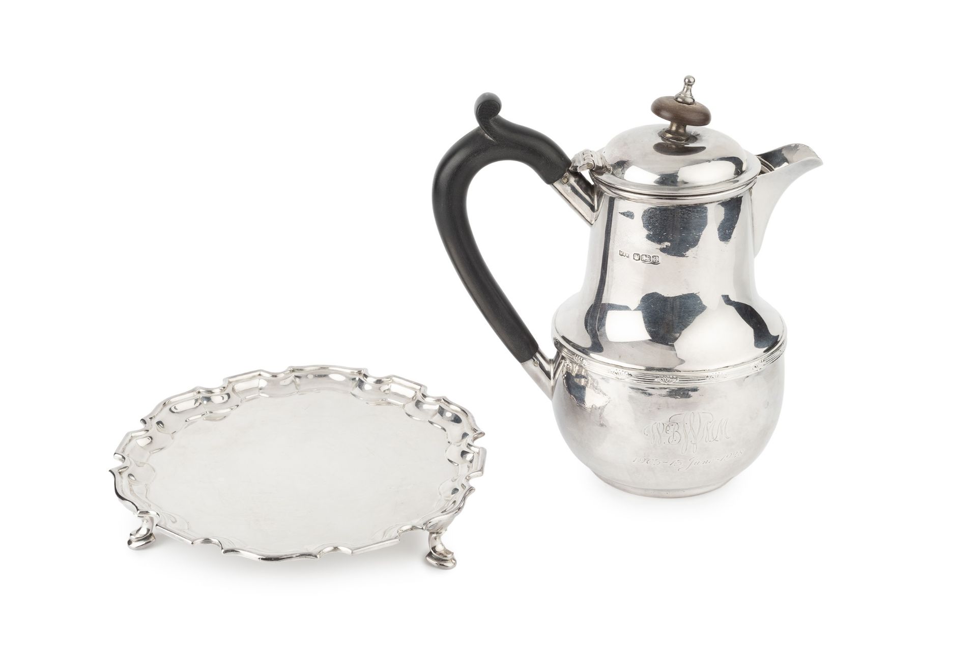 A George V silver hot milk pot, of baluster form with hinged cover and ebonised handle, by