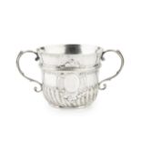 A Queen Anne Britannia standard silver porringer, the ropetwist girdled and part lobed body