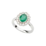 An emerald and diamond dress ring, the oval cut emerald approx 1.17ct within a border of fourteen