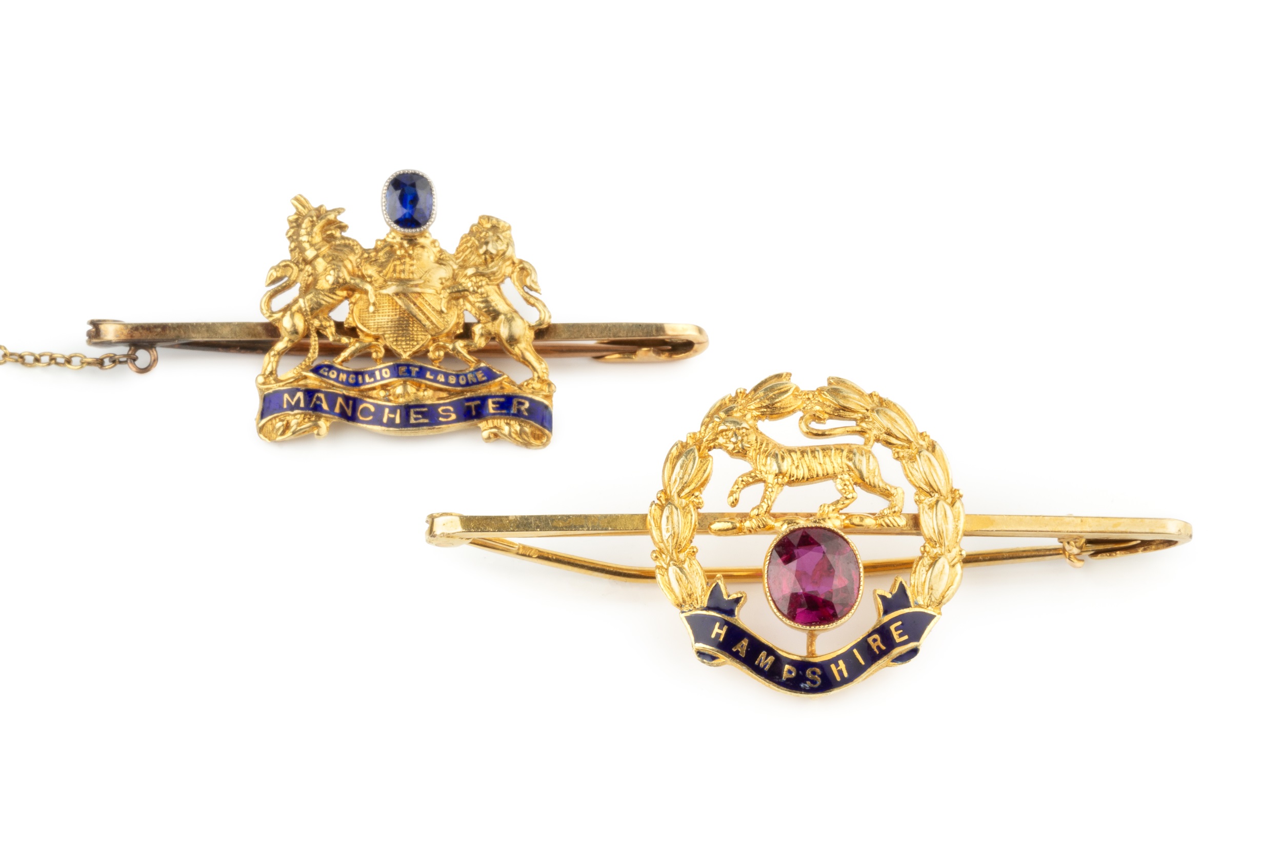 A 15ct gold, enamel and gem set regimental brooch, for the Hampshire regiment, of wreath design with