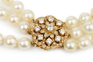 A triple strand cultured pearl necklace, the 18ct yellow gold clasp set with nine brilliant cut