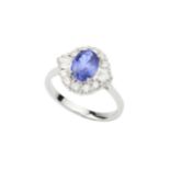 A tanzanite and diamond cluster ring, the oval cut tanzanite of approx 1.26ct within a border of