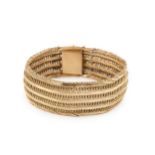 An 18ct gold mesh link bracelet, with chevron and baton links, the clasp stamped 750, 19cm long