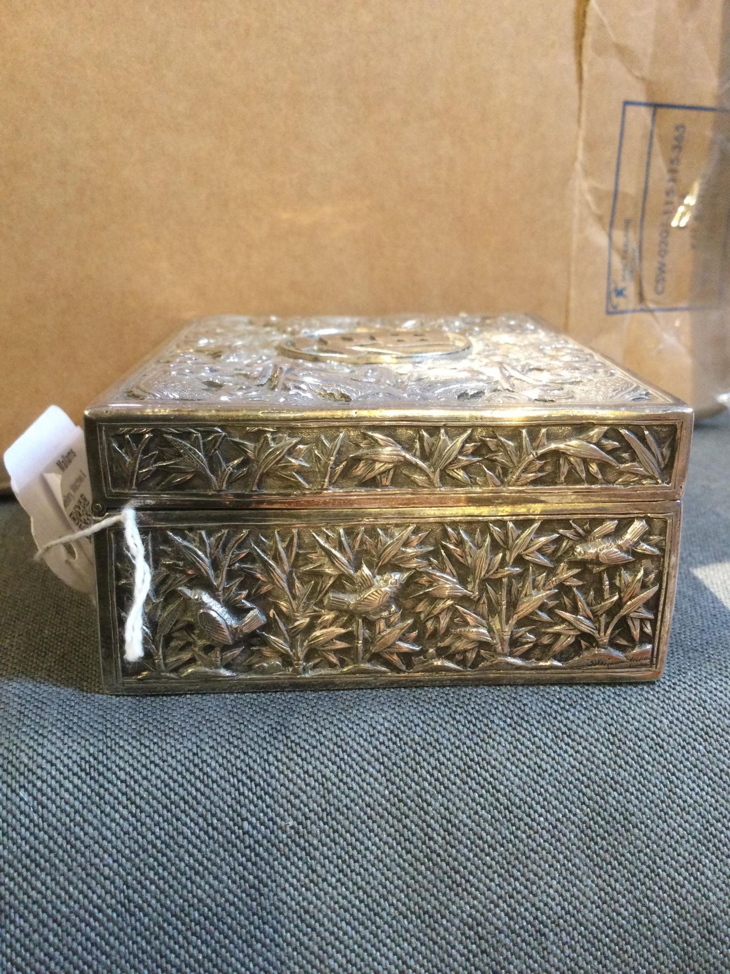 A Chinese silver rectangular box, with hinged cover, embossed and engraved with dragons amidst - Image 7 of 10