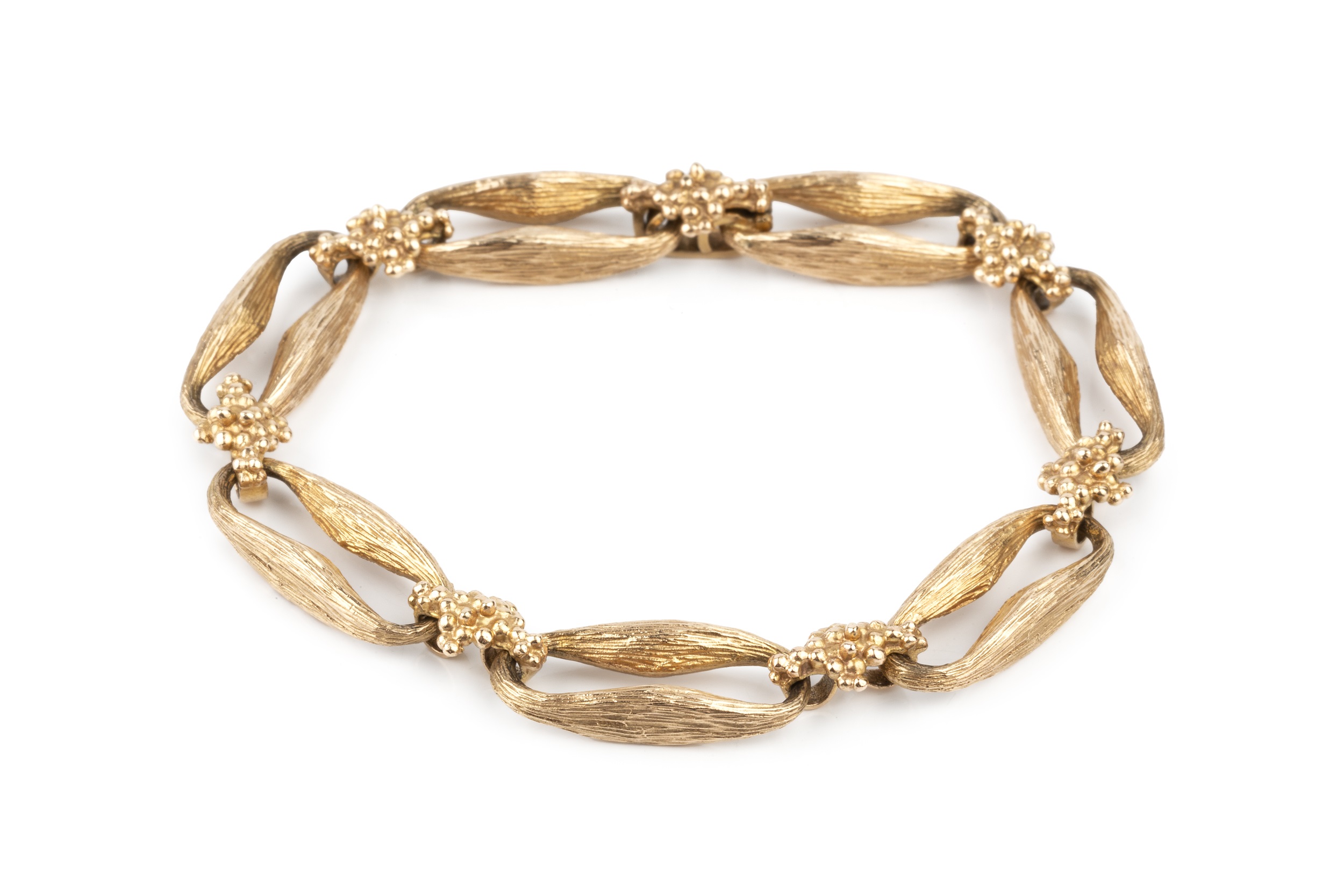 A 9ct gold bracelet, formed of shaped and textured elongated oval links with cluster spacers
