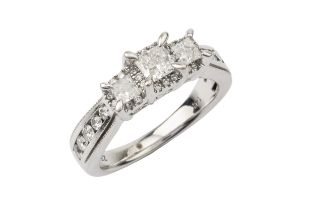 A diamond 'trilogy' ring, the three principal princess cut stones each within a border of small