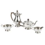 A George V silver three piece tea service, with beaded borders, the teapot with composite handle and